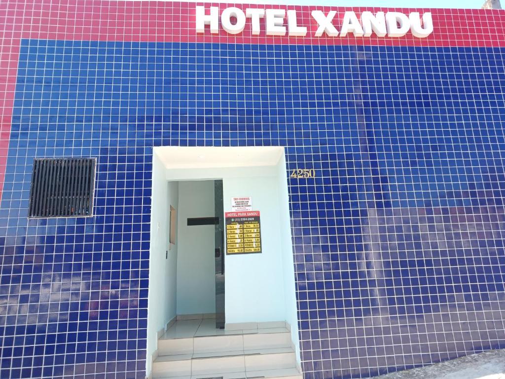 a blue tiled building with a hotel karma sign on it at hotel xandu in Sao Paulo