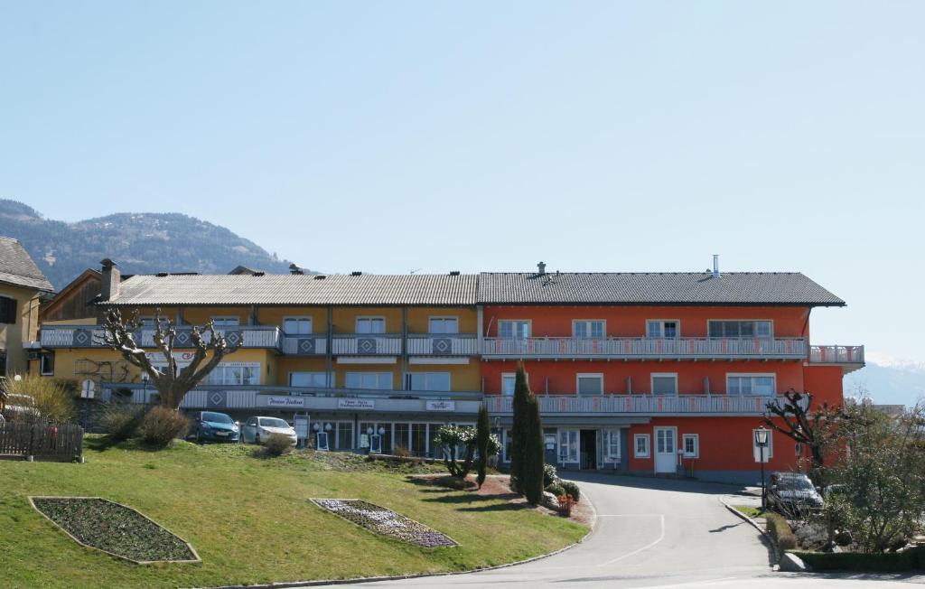 a building with a road in front of it at Pension Pleikner in Millstatt