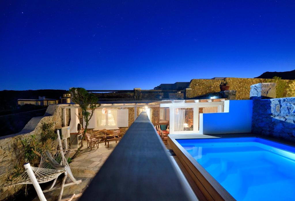 a villa with a swimming pool at night at Villa Princess 6 private with Pool Panormos Beach in Panormos Mykonos