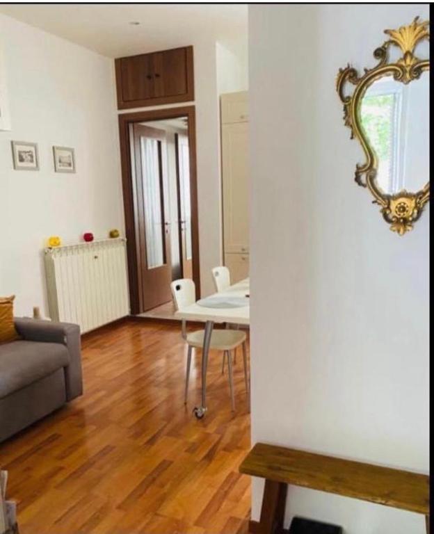 a living room with a table and a mirror on the wall at Al piccolo castelliere in Trieste