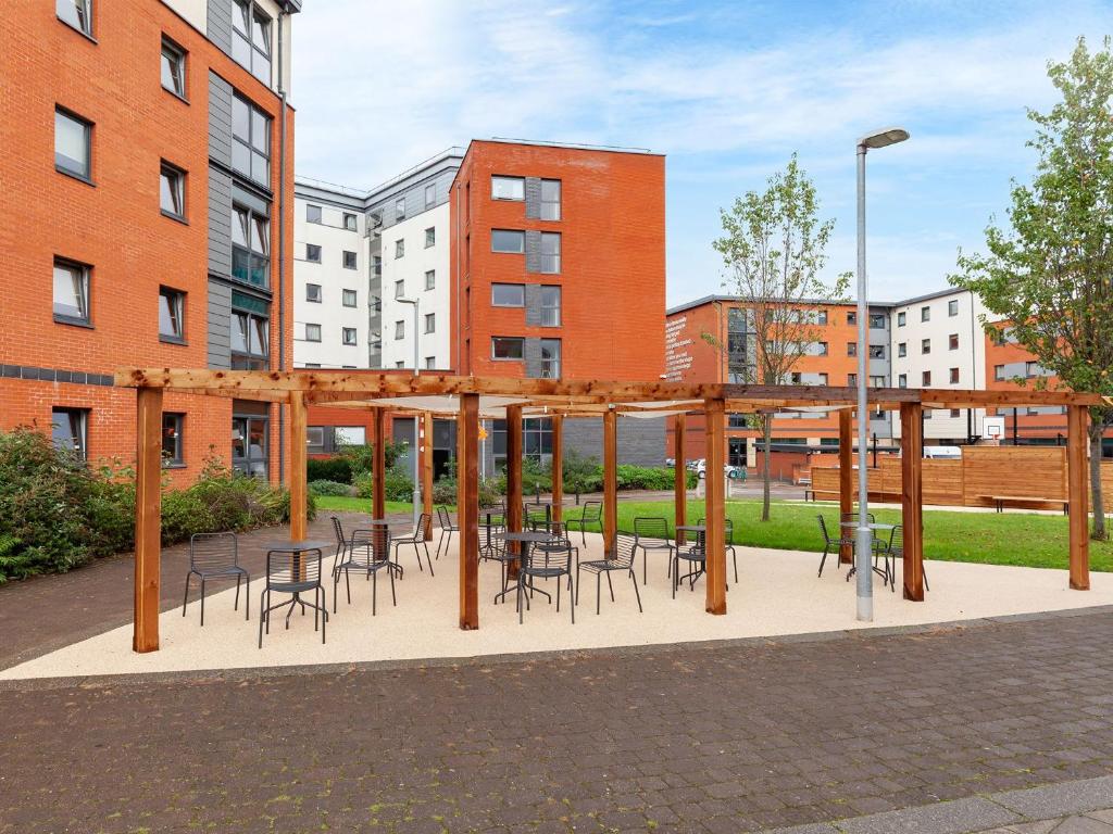 a pavilion with chairs and tables in front of a building at For Students Only - Marvelous Private Ensuite Rooms at The Forge Sheffield in Sheffield