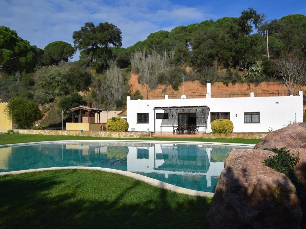 a swimming pool in front of a white building at Villa pedralta in Sant Feliu de Guíxols