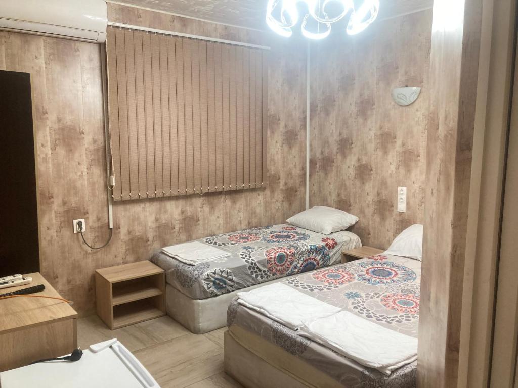 a room with two beds and a mirror at Guesthouse Dune in Sofia