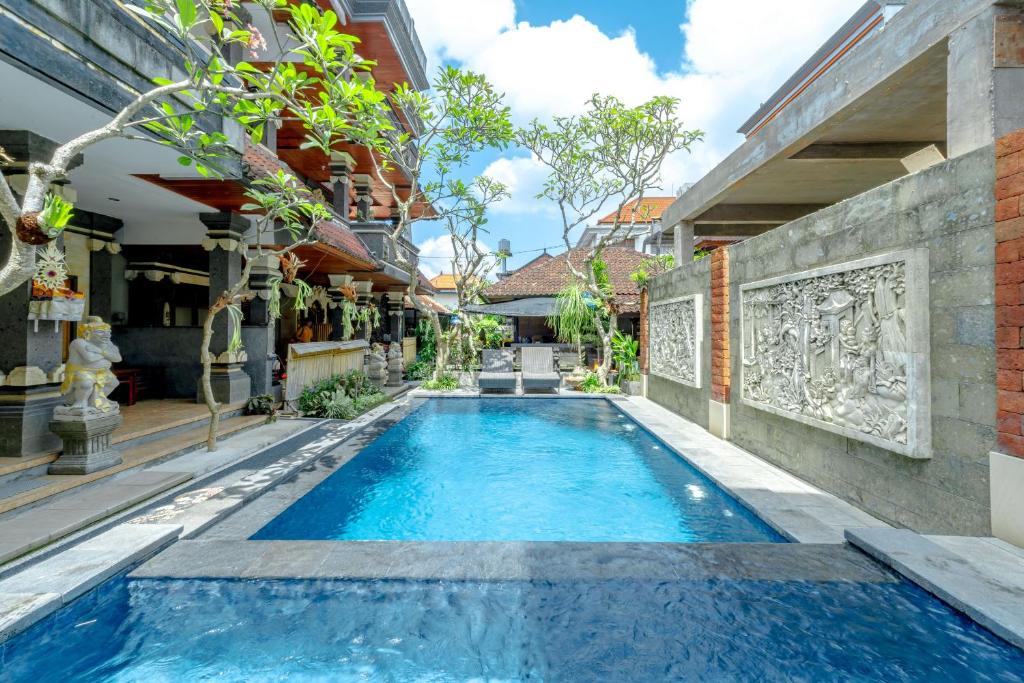 a swimming pool in the courtyard of a house at Suarsena House Ubud in Ubud