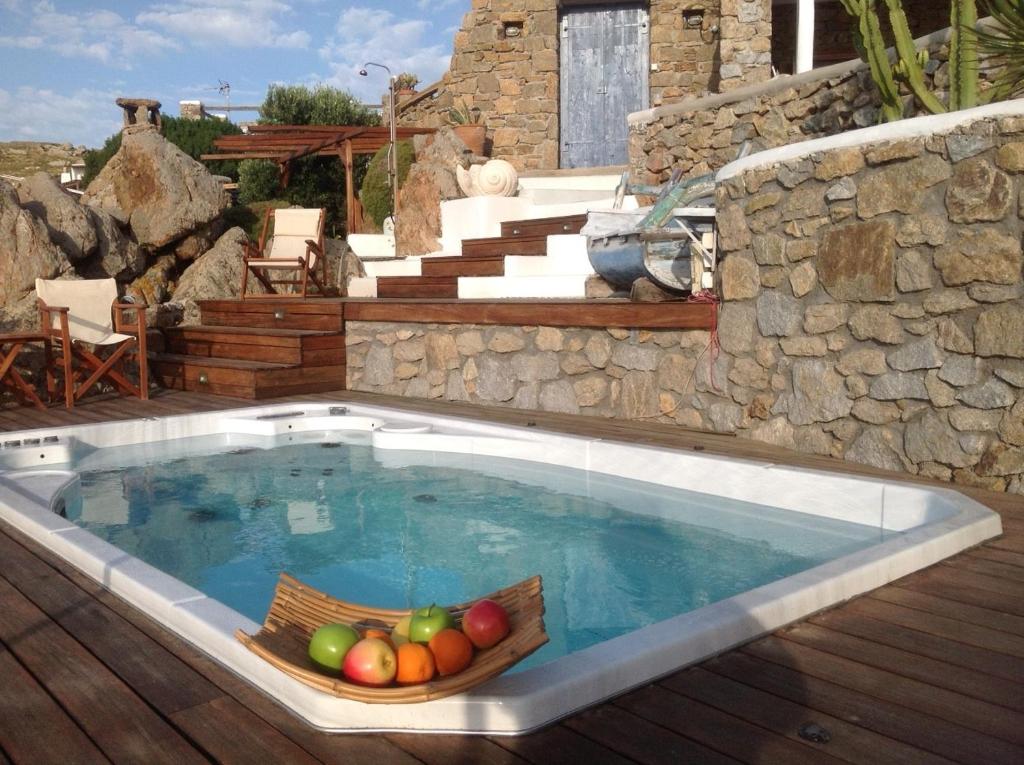 a swimming pool with a bowl of fruit in it at Villa Princess 5 4Bed with Small Tub Panormos Beach in Mykonos