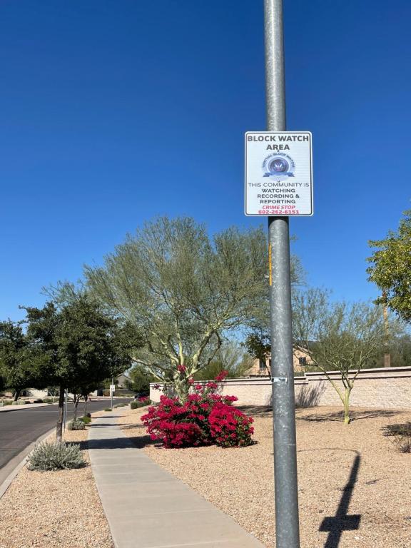 a sign on a pole next to a sidewalk at Modern Private room By Cardinals State Farm stadium in Phoenix