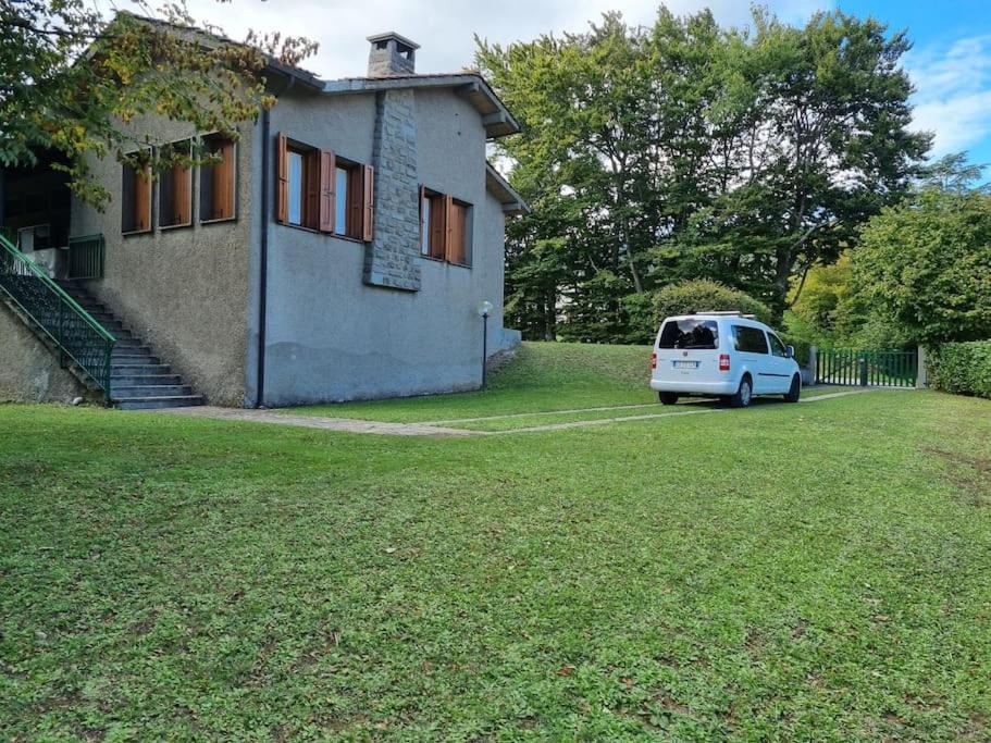 una furgoneta blanca estacionada frente a una casa en Villetta con ampio giardino, en Montepiano