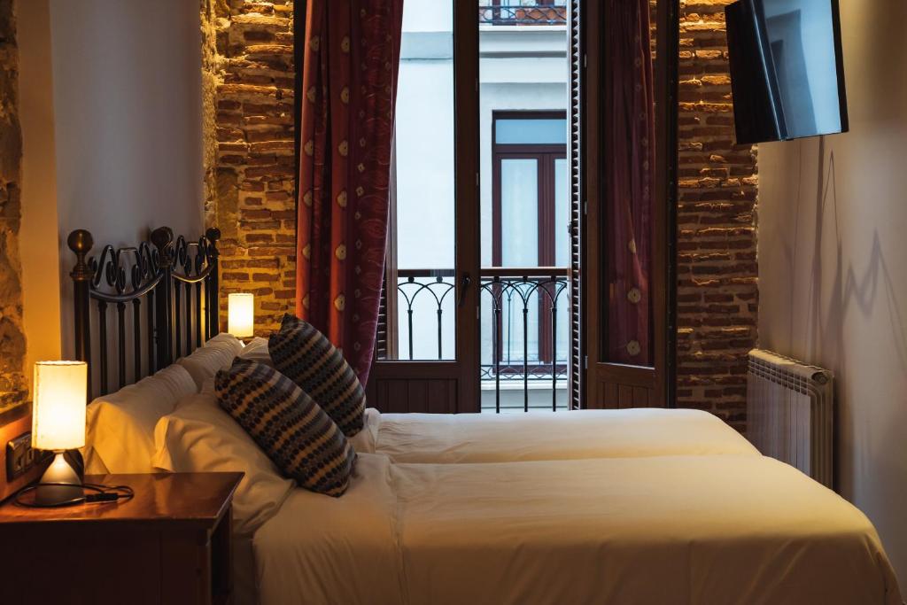 a hotel room with a bed and a window at San Sebastián DOT Rooms in San Sebastián