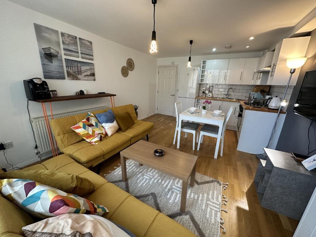 a living room with a couch and a table at Stoke Newington Deluxe Flat in London