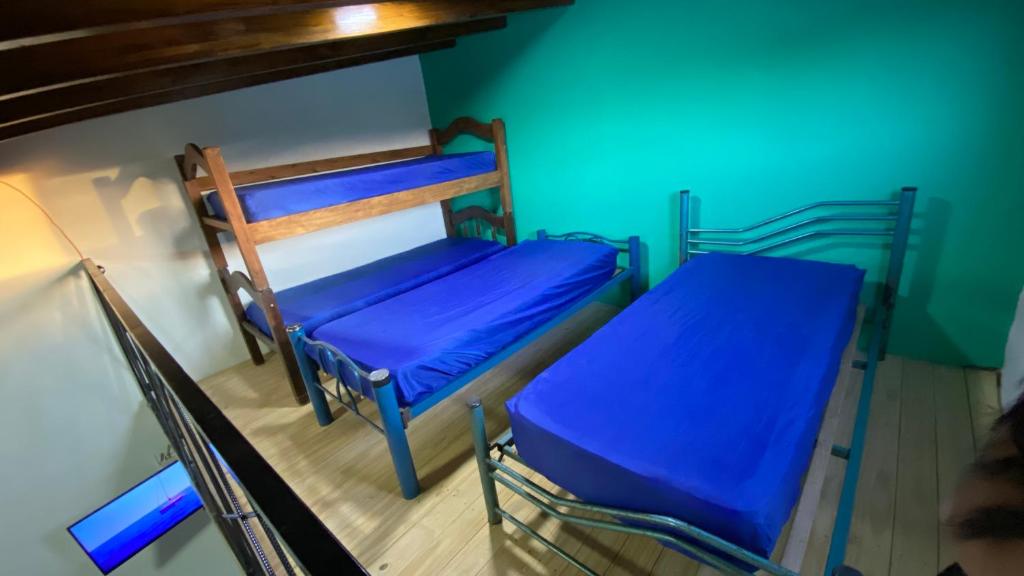 two bunk beds in a room with blue lights at House-Mendoza in Maipú