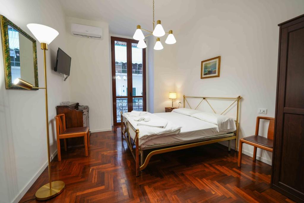 a bedroom with a bed and a television in it at Neapolitan Soul By Dimorra in Naples