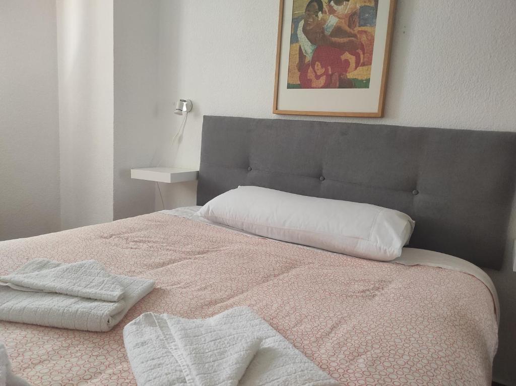 a bedroom with a bed with two towels on it at Vive Huelva MARINA WIFI 300 VFTHU01194 in Huelva
