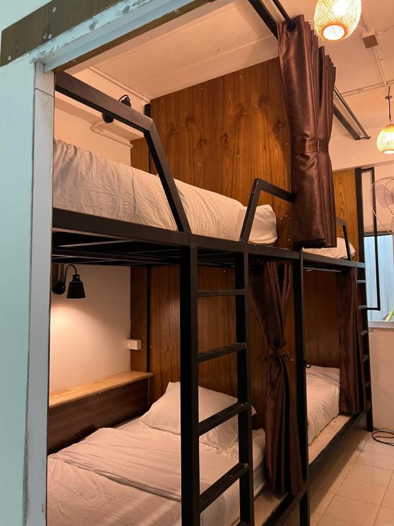 a couple of bunk beds in a room at Happiness Hostel in Phra Ae beach