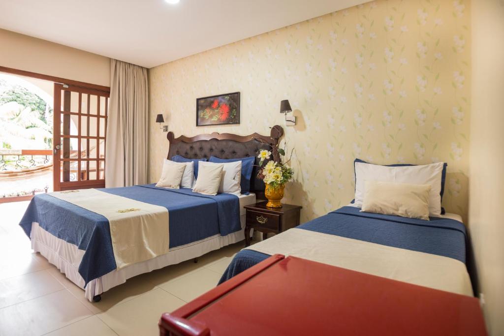 Cama ou camas em um quarto em Terra dos Diamantes Hotel