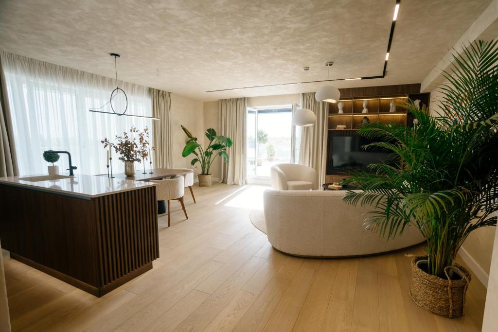 a living room with a couch and a table at Penthouse Lebada Lake View in Pantelimon
