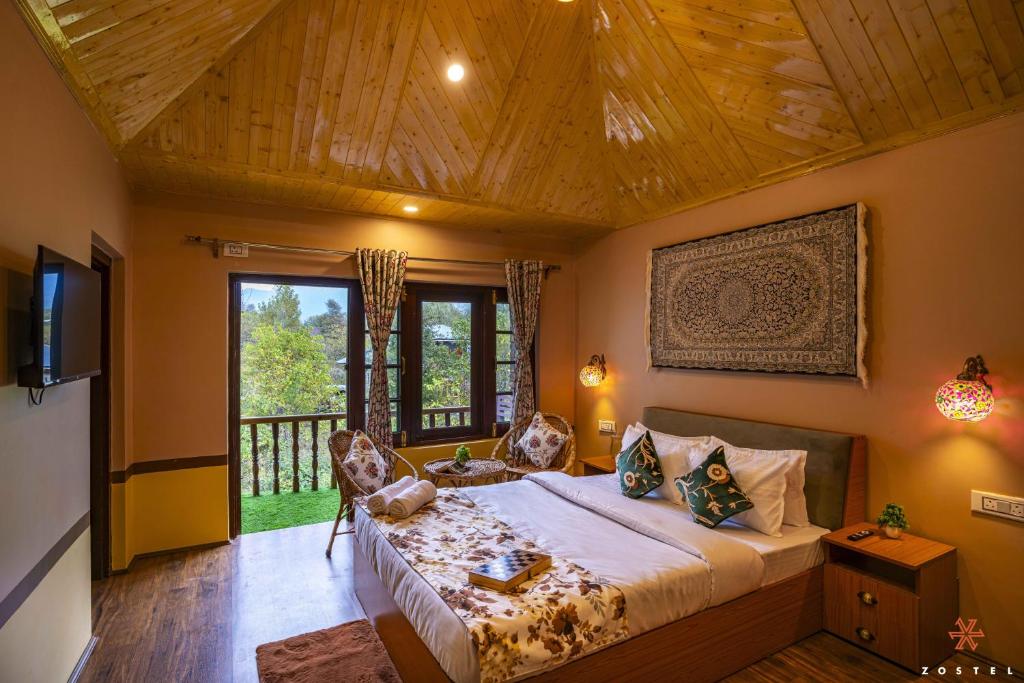 a bedroom with a large bed with a wooden ceiling at Zostel Pahalgam in Pahalgām