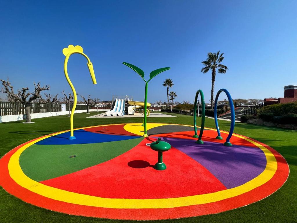 a playground in a park with a colorful at Camping Resort Els Pins in Malgrat de Mar