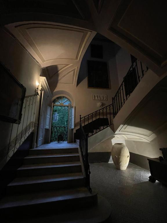 a dark room with stairs and a stair case at Palazzo Mazziotti in Celso