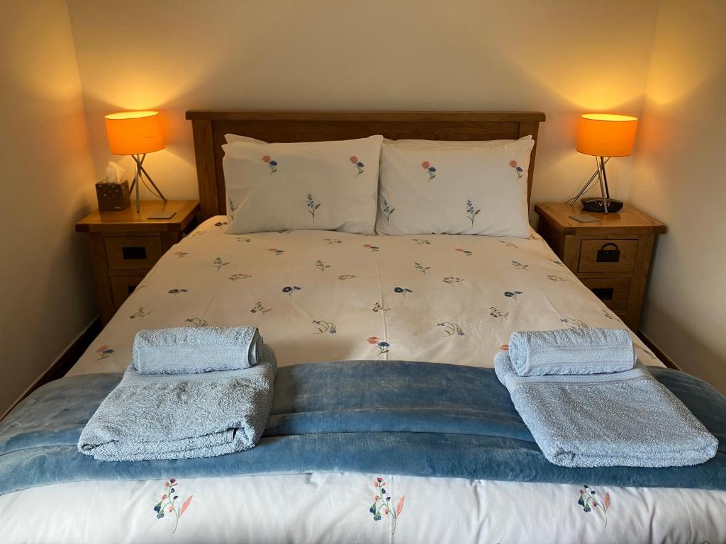a bedroom with a bed with two towels on it at The Dale at Greystones - Luxurious annexe with stunning view in Buckden