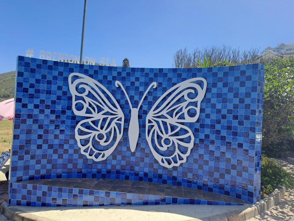 a blue tile with butterflies on top of it at Ellipsis Cottage in Knysna