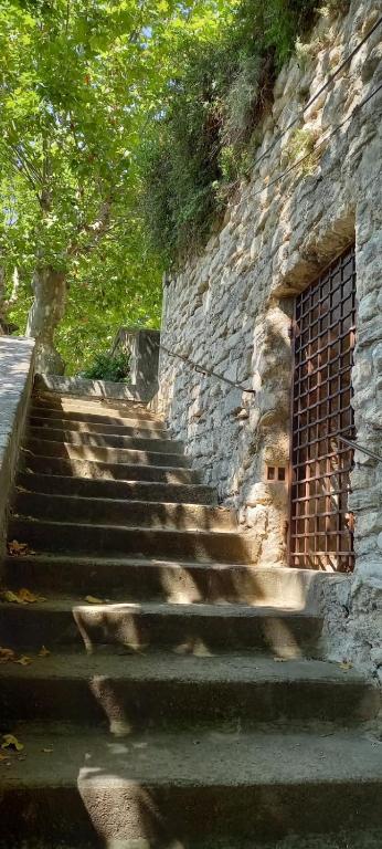a set of stairs next to a stone wall at Charming Village Getaway in Bonnieux in Bonnieux