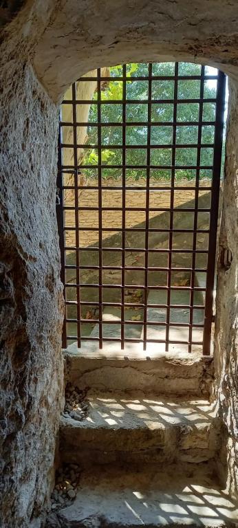 a window in a stone building with bars on it at Charming Village Getaway in Bonnieux in Bonnieux