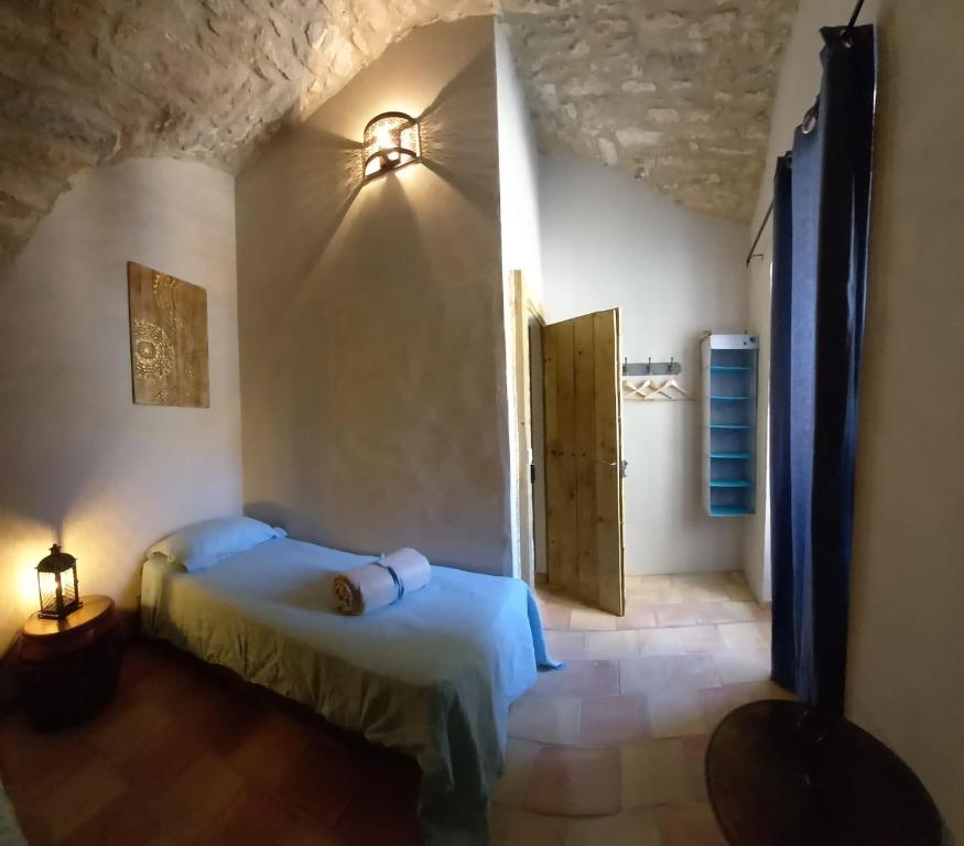 a bedroom with a bed in a room with a door at Charming Village Getaway in Bonnieux in Bonnieux