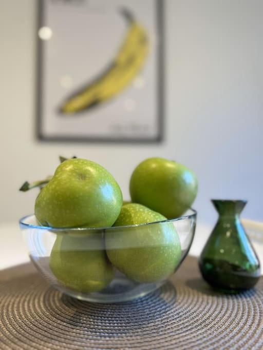 a bowl of green pears and a banana on a table at Newly refurbished 2 bed- Didcot 