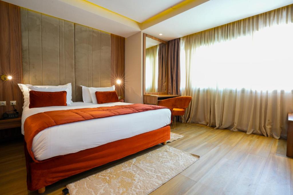 Postel nebo postele na pokoji v ubytování First Suites Hôtel