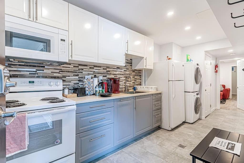 a kitchen with blue cabinets and white appliances at Executive Apartment - 2BDR Parking Self-check in - Walkout basement Lower Unit in Mississauga