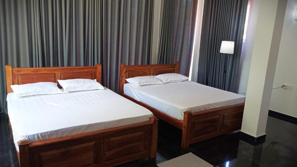 Postel nebo postele na pokoji v ubytování Grand Okka Hotel