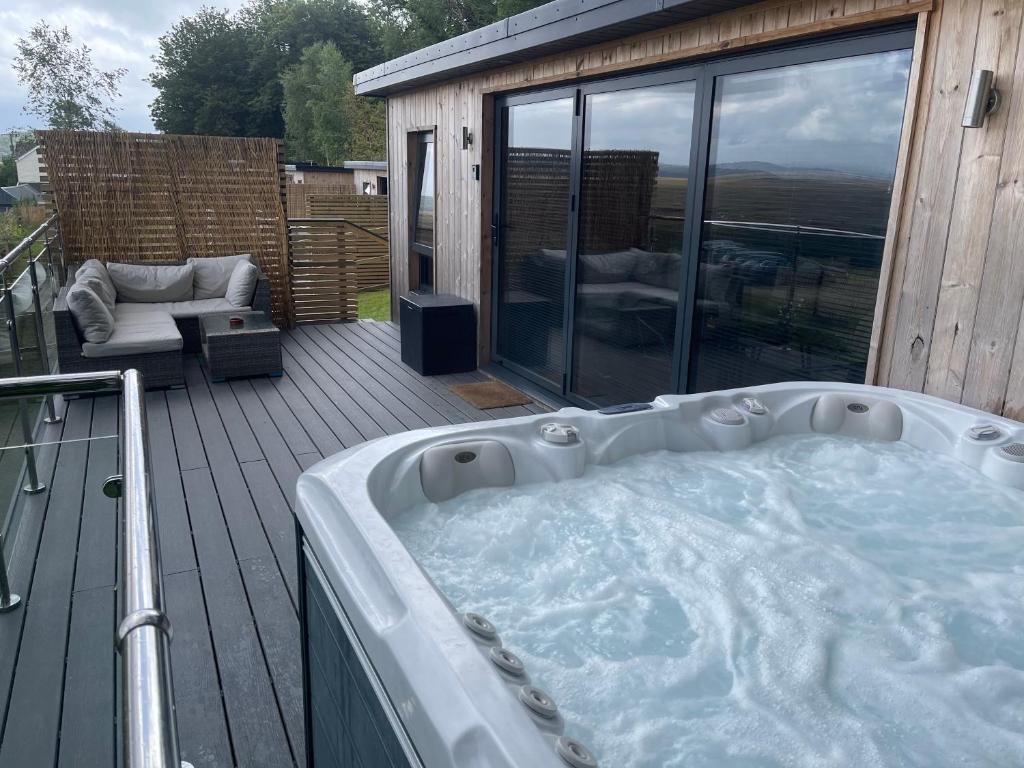 a hot tub on the deck of a house at The Rhossili bay secret in Swansea
