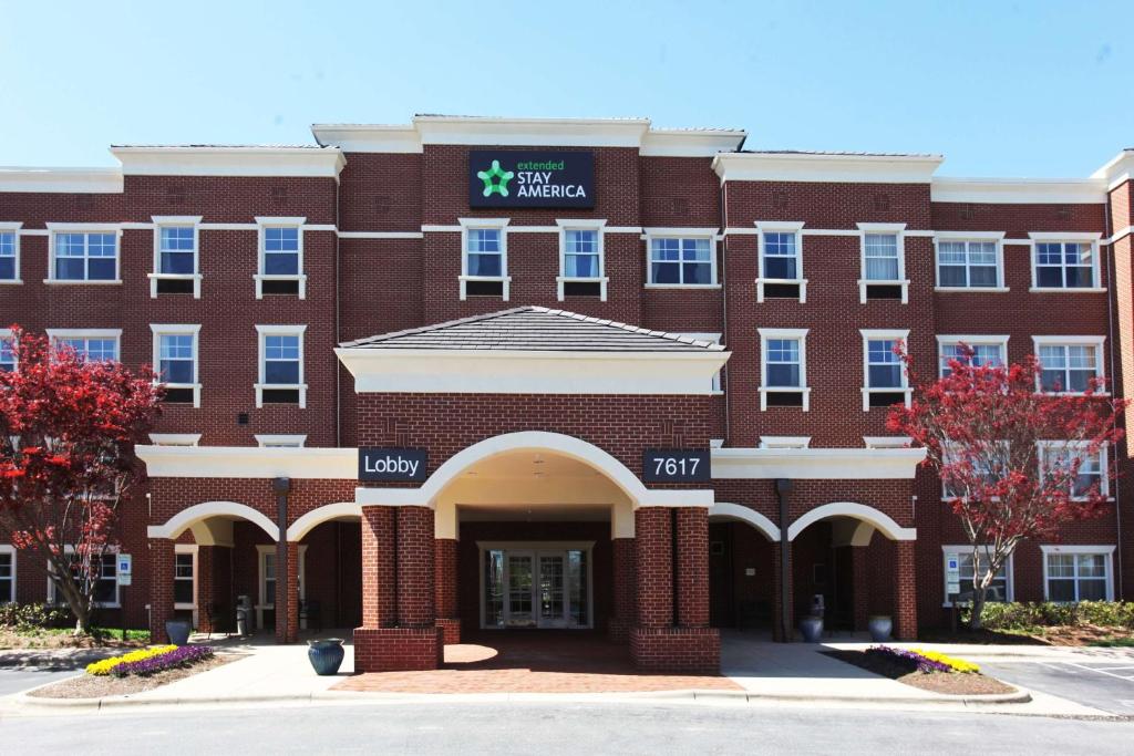 an exterior view of a red brick building at Extended Stay America Suites - Greensboro - Airport in Greensboro