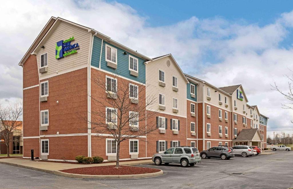 a large building with a sign on the side of it at Extended Stay America Select Suites - Cincinnati - Florence - Airport in Florence