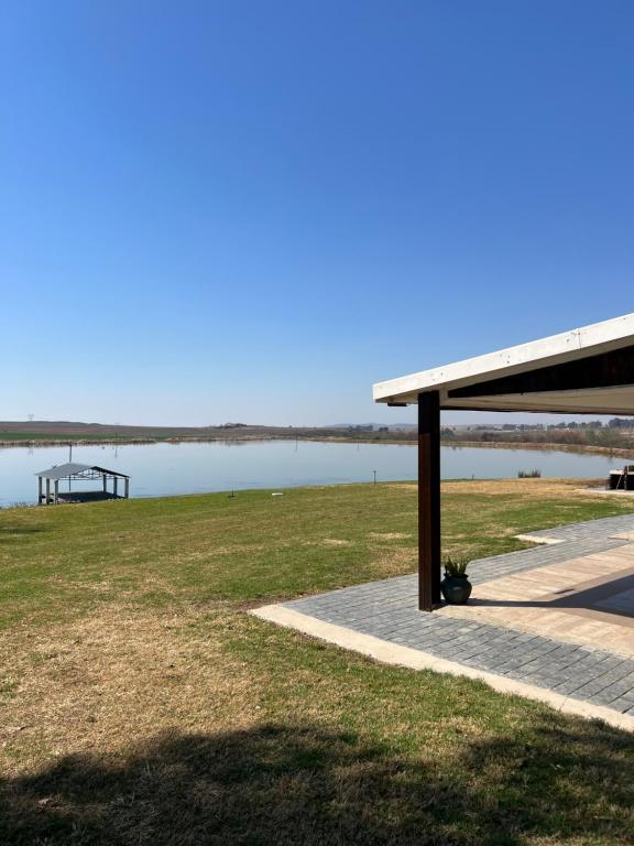a picnic shelter next to a body of water at Berg guest farm in Winterton