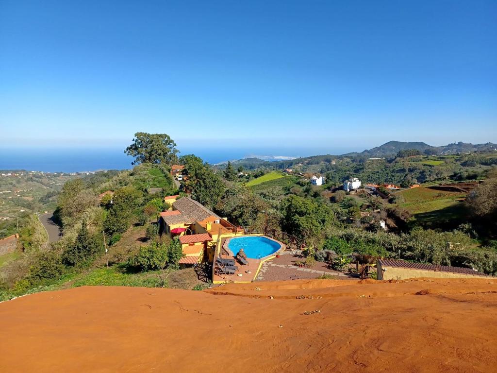 a house on top of a hill with a pool at Finca Naturacanaria in Moya