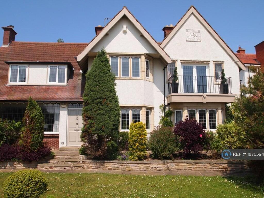 a large white house with a tree in the yard at White House in Lytham St Annes