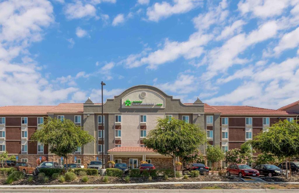 a hotel building with cars parked in a parking lot at Extended Stay America Suites - Redlands in Redlands