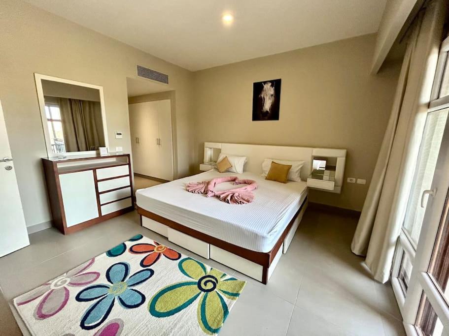 a bedroom with a bed and a flower rug at SunShine AbuTig Marina in Hurghada