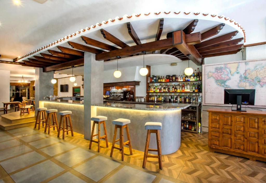 a bar in a restaurant with stools at Hotel Ramis in Ondara