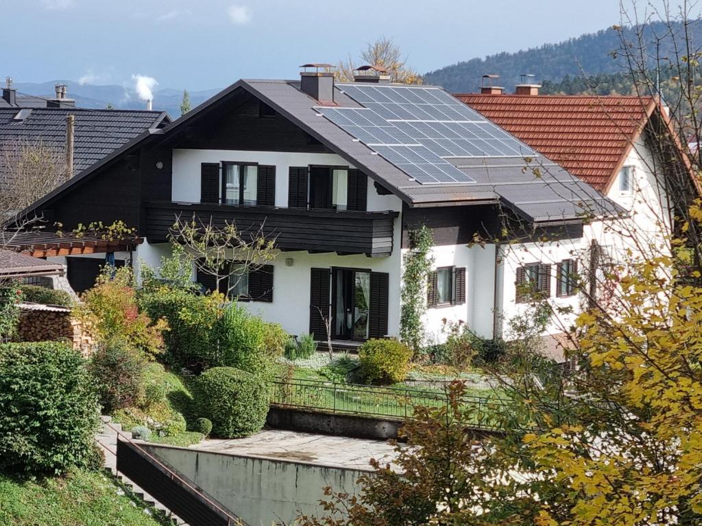 a house with solar panels on the roof at Apartman Ksenija Delnice in Delnice