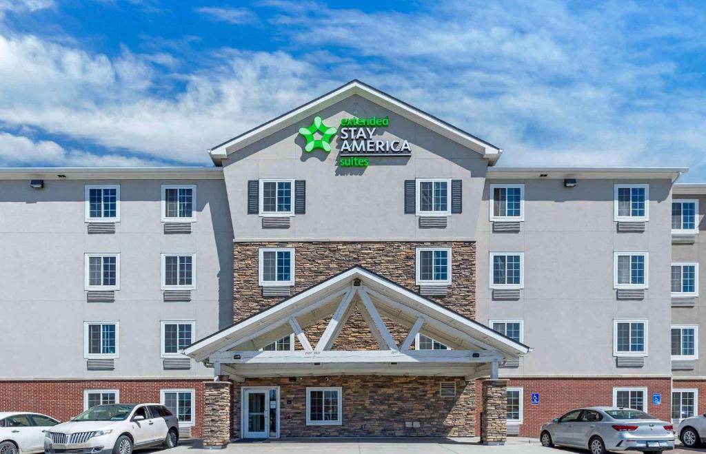 a large hotel with cars parked in front of it at Extended Stay America Suites - Denver - Airport in Aurora