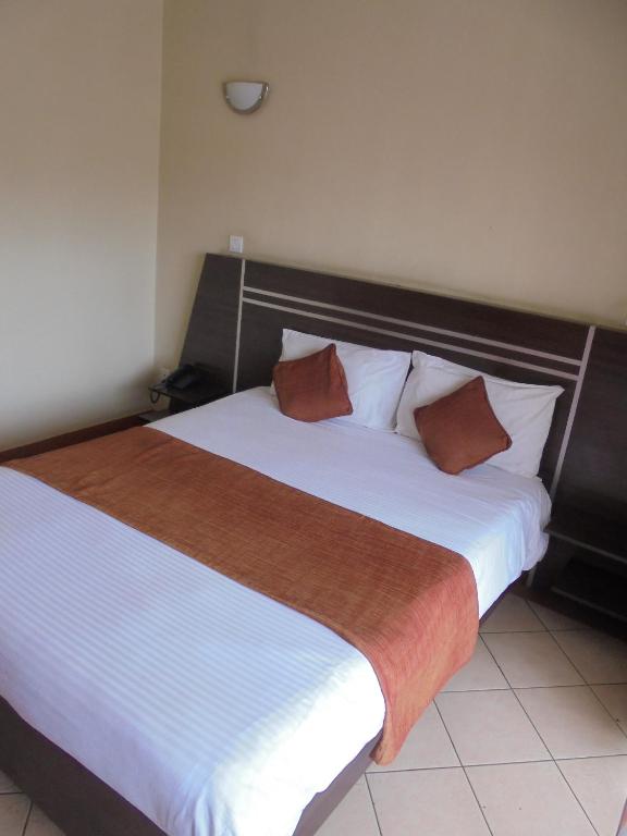Postel nebo postele na pokoji v ubytování Nairobi Transit Hotel