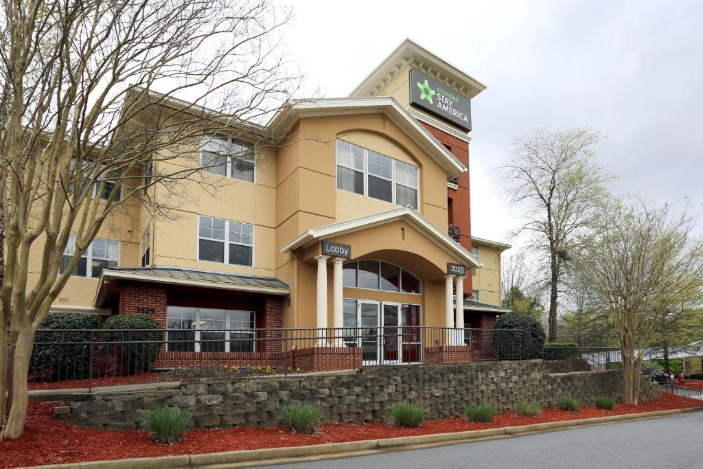 a yellow building with a sign on top of it at Extended Stay America Suites - Atlanta - Alpharetta - Northpoint - West in Alpharetta