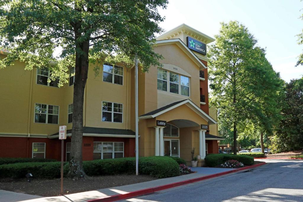a yellow and red building with a sign on it at Extended Stay America - Atlanta - Marietta - Interstate N. Pkwy in Atlanta