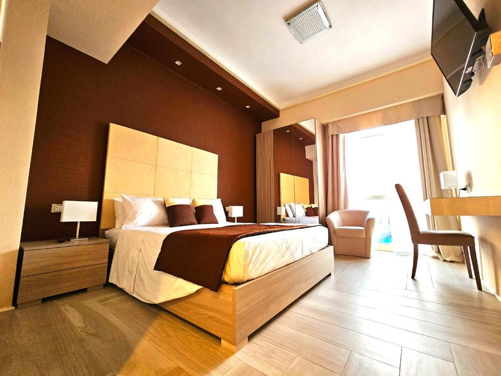 a bedroom with a bed and a desk and a chair at Trilogy Prestige - Central Premium Suites in Lecce