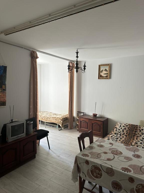 a bedroom with a bed and a tv in it at Уютная квартира in Yerevan