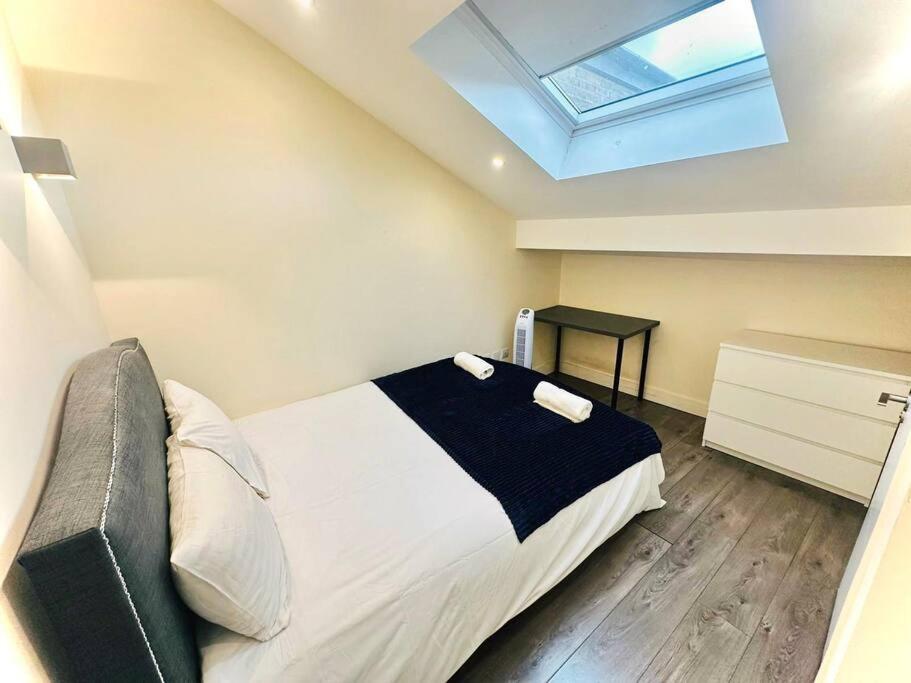 a bedroom with a bed and a skylight at Luxurious 2 Bedroom flat in Central London in London