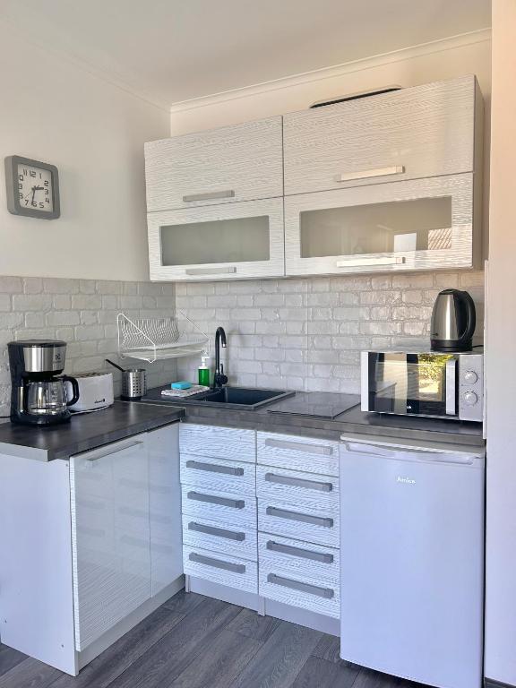 Kuchyň nebo kuchyňský kout v ubytování Apartamenty Nexo