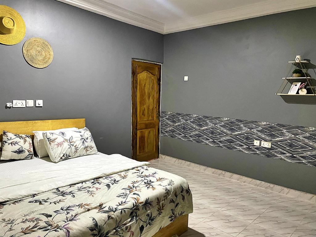 a bedroom with a bed and a wall at Tamaniroom- a private 1bed in Tamale